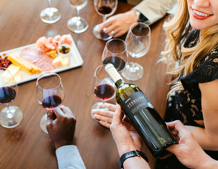 A photo of a group of Wine Club members enjoying each others' company in nature.